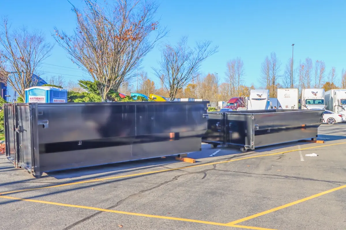 Professional dumpster rental service with roll-off container on residential driveway in Williamstown